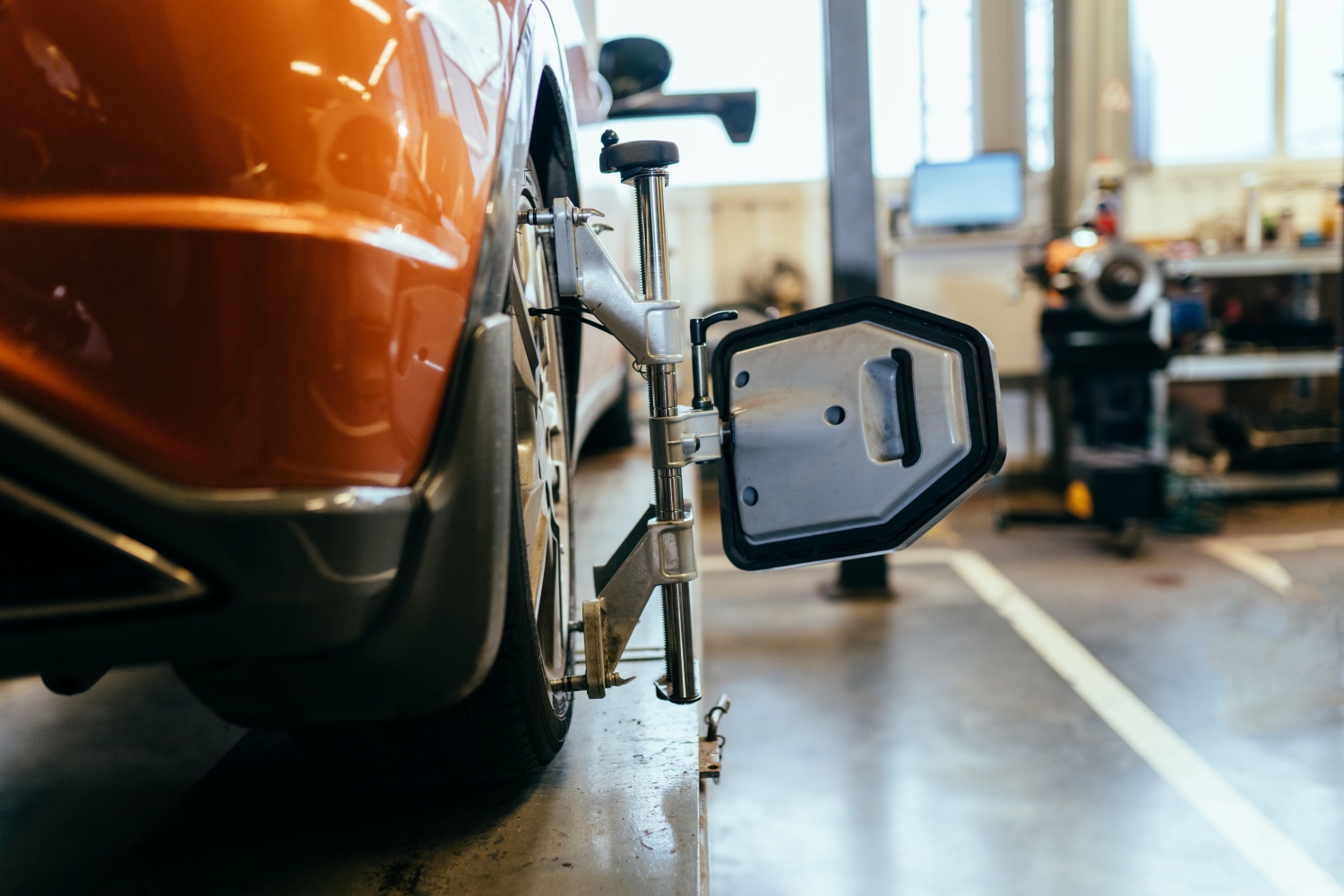 Technician performing wheel alignment at DriveTime Automotive Salem OR