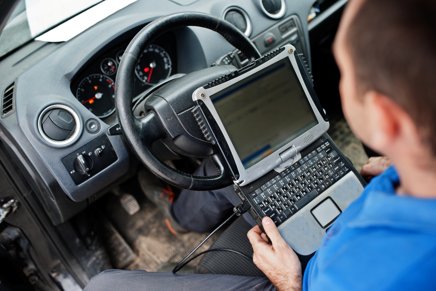 Technician performing computer diagnostics on a vehicle for an Auto Repair in Salem, Oregon at DriveTime Automotive