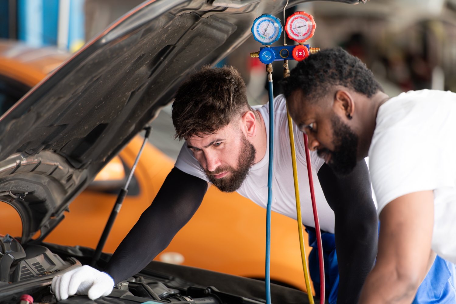 Technician performing a courtesy vehicle inspection at DriveTime Automotive in Salem, OR.