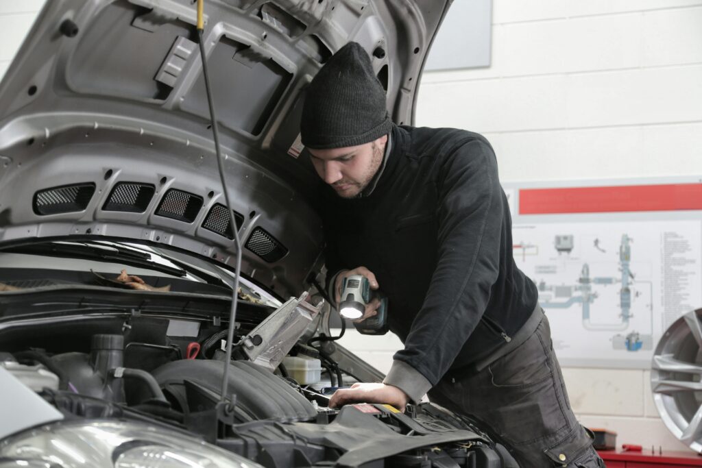 Mechanic performing electric auto repair.