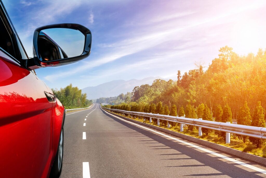 Car driving smoothly on the freeway, showcasing the importance of regular vehicle maintenance for performance and safety.