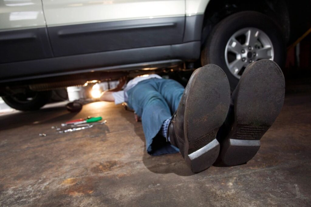 Technician performing suspension repair on a vehicle at DriveTime Automotive in Salem, OR, ensuring optimal vehicle performance and safety.