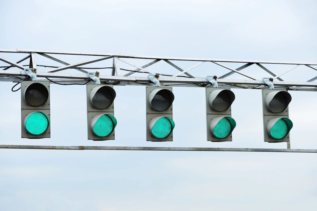 Five illuminated signal lights on a car dashboard, representing warning indicators such as the check engine light, oil pressure light, and battery alert, emphasizing the importance of addressing car issues promptly